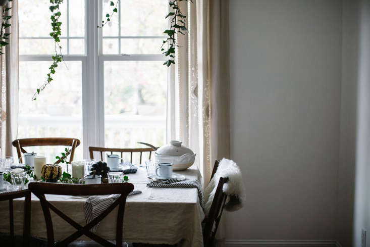 Foraged ivy vines were used to create a Thanksgiving tableau here (in both the hanging and tabletop centerpieces), but the idea would also work for a wedding reception. Photograph by Beth Kirby for Gardenista, from Thanksgiving on a Budget: 7 Tips for Tabletop Decor from Stylist Beth Kirby.