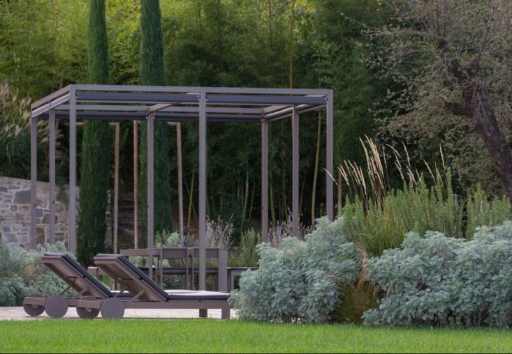 Silvery gray-green clouds of artemisia and feathery grasses soften the edge of a planting bed. Photography by Dario Fusaro courtesy of Cristiana Ruspa. For more, see Landscape Architect Visit: A Hazy Dreamscape in Northern Italy by Cristiana Ruspa.