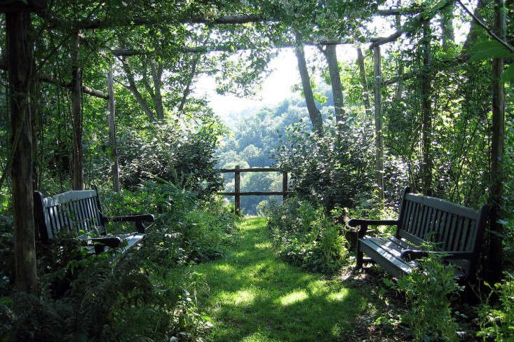 Two garden benches face one another in a shady spot beneath a pergola at Torrecchia Vecchia, designed by Dan Pearson. Photograph by Huw Morgan. See more of this garden at Paradise Found: Designer Dan Pearson’s Modern Garden for a Medieval Castle.