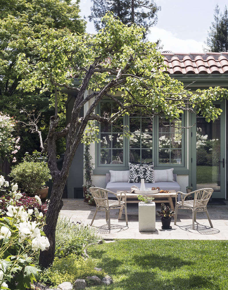 Michelle and Josh’s backyard garden in Mill Valley has a bluestone-paved seating area. Shrubs line the perimeter, creating a private entertaining space. Photograph by Matthew Williams for Gardenista.