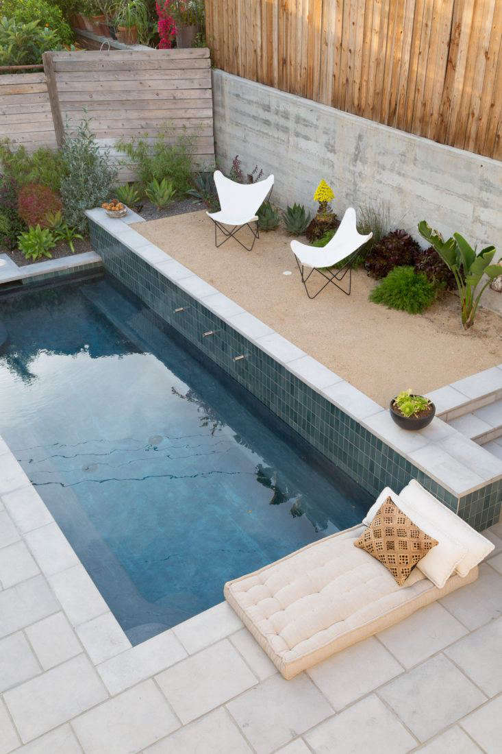 Next to the pool, a gravel courtyard is like a luxe mini beach in costume designer Gordana Golubovic’s luxe, secluded LA backyard. Photograph by Lauren Moore.