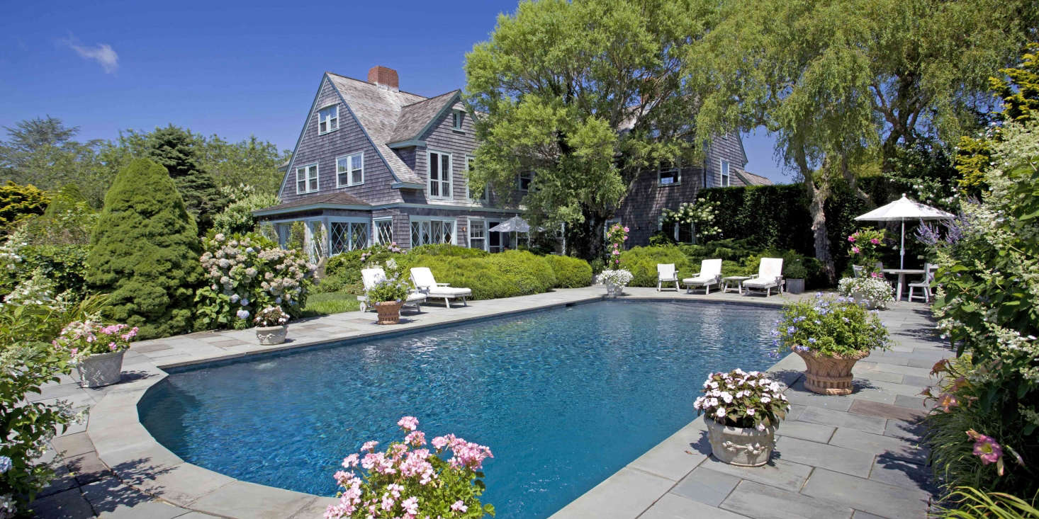 At Grey Gardens, where the swimming pool is surrounded by bluestone pavers, landscape designer Victoria Fensterer created a series of outdoor rooms that guests could discover as they wandered through the garden.