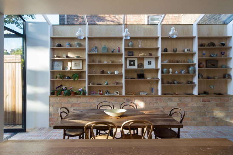 Got open shelving? Treat them like a shopkeeper would and think of them as opportunities to both store and display. Photograph courtesy of Neil Dusheiko Architects, from Kitchen of the Week: An Architect’s Labor-of-Love Kitchen, Art Gallery Included.