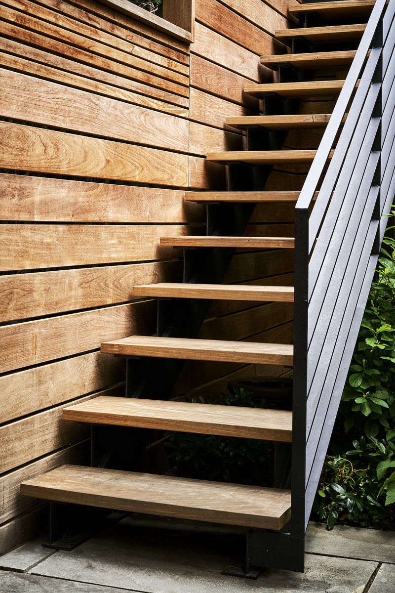 The ipe stairway and fence in detail. The fence provides privacy, while thinner strips of wood at the top still allow for air flow.