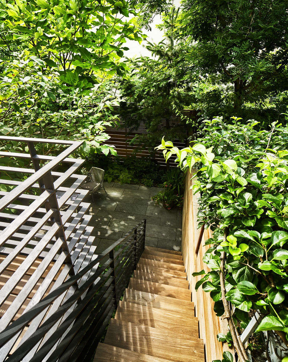 The stairway, deck, and fence are all made of water-repellent ipe wood and fabricated by Gogoleyed. The railing is painted steel, fabricated by All City Ironworks.