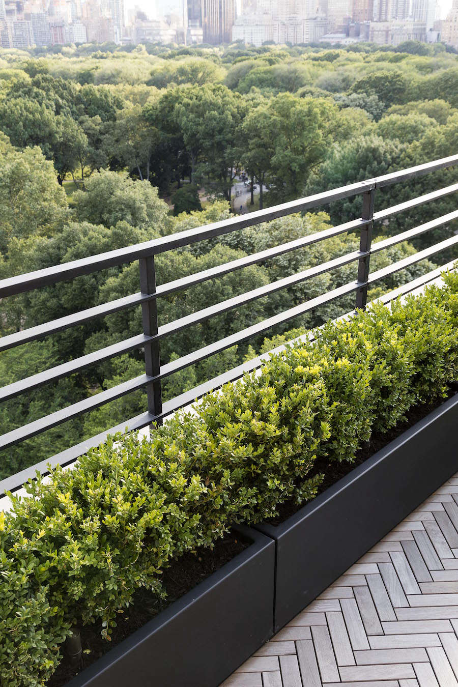 The unadorned powder coated planters were chosen for their light weight and durability and were custom built.