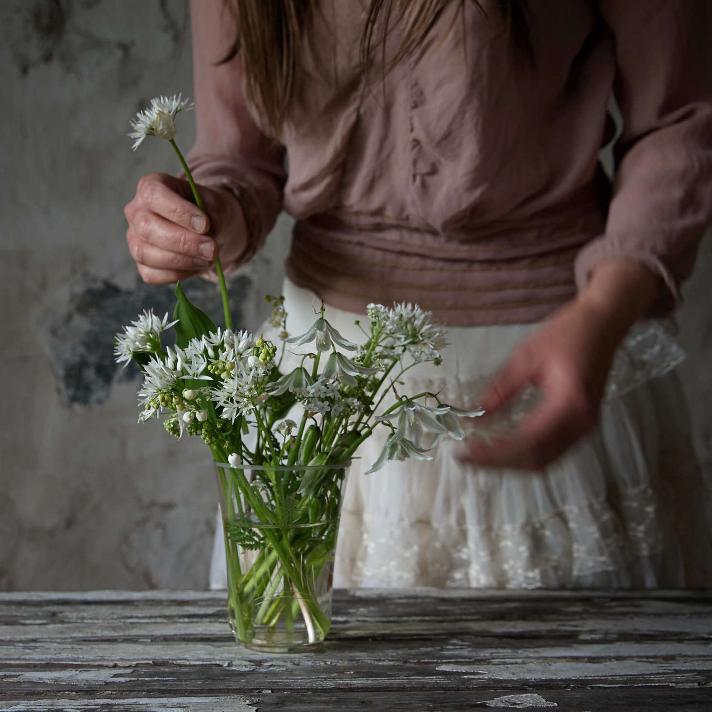 A white arrangement of drooping star-of-Bethlehem, ramsons, lily of the valley, white forget-me-not, and cow parsley, was plucked from the woodland near Juliane