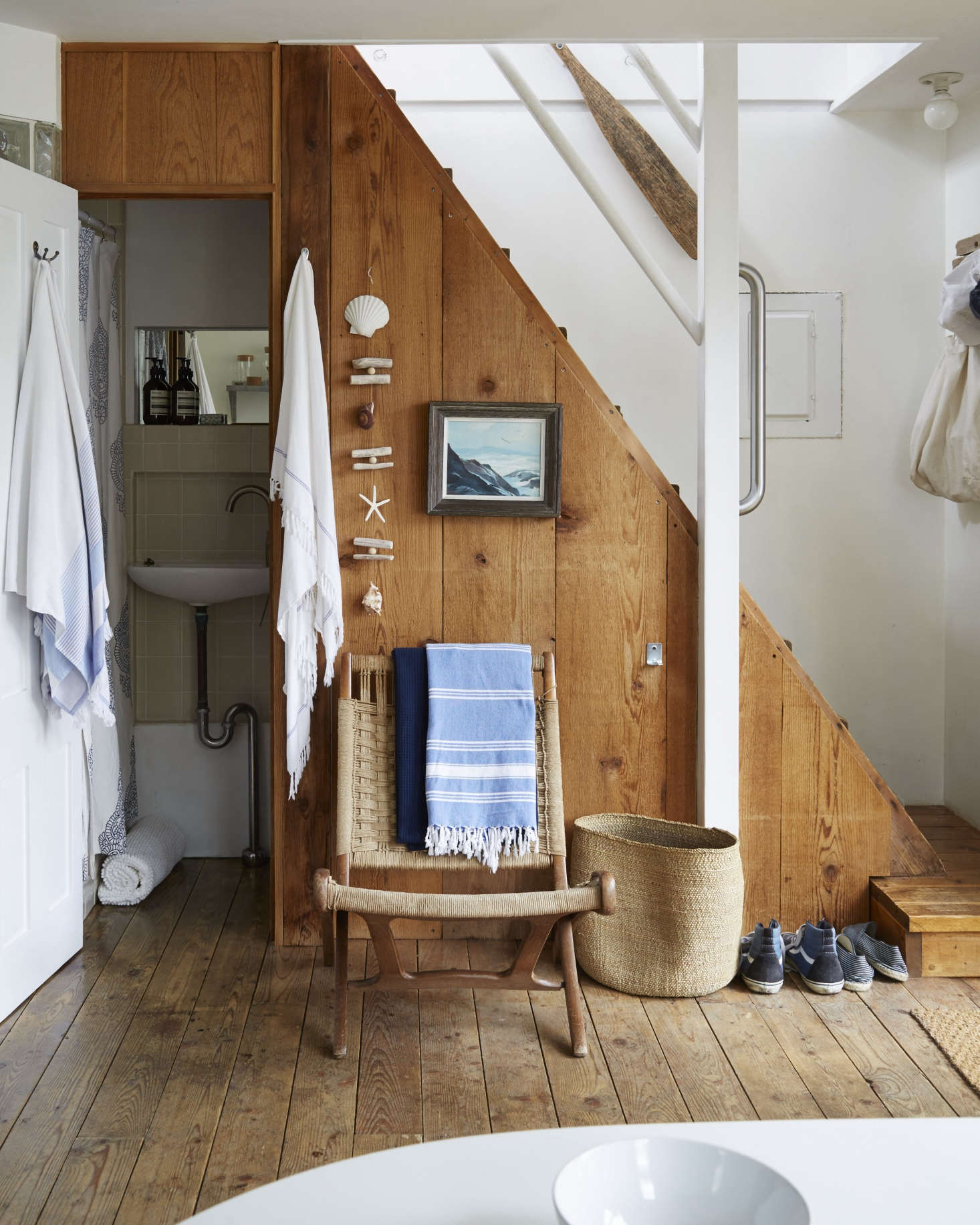 Designer Glenn Ban leaves shoes right by the door in his summer rental. See A Beach Cottage in Provincetown, Styled for Budget-Minded Summer Living. Photograph by Stephen Johnson.
