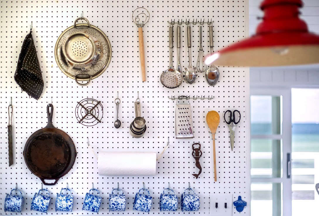A highly organized yet somehow casual and relaxed kitchen, thanks to a hardworking pegboard wall. Photograph by Justine Hand for Remodelista, from Kitchen of the Week: A Compact, Nautical Entertaining Kitchen on Cape Cod.