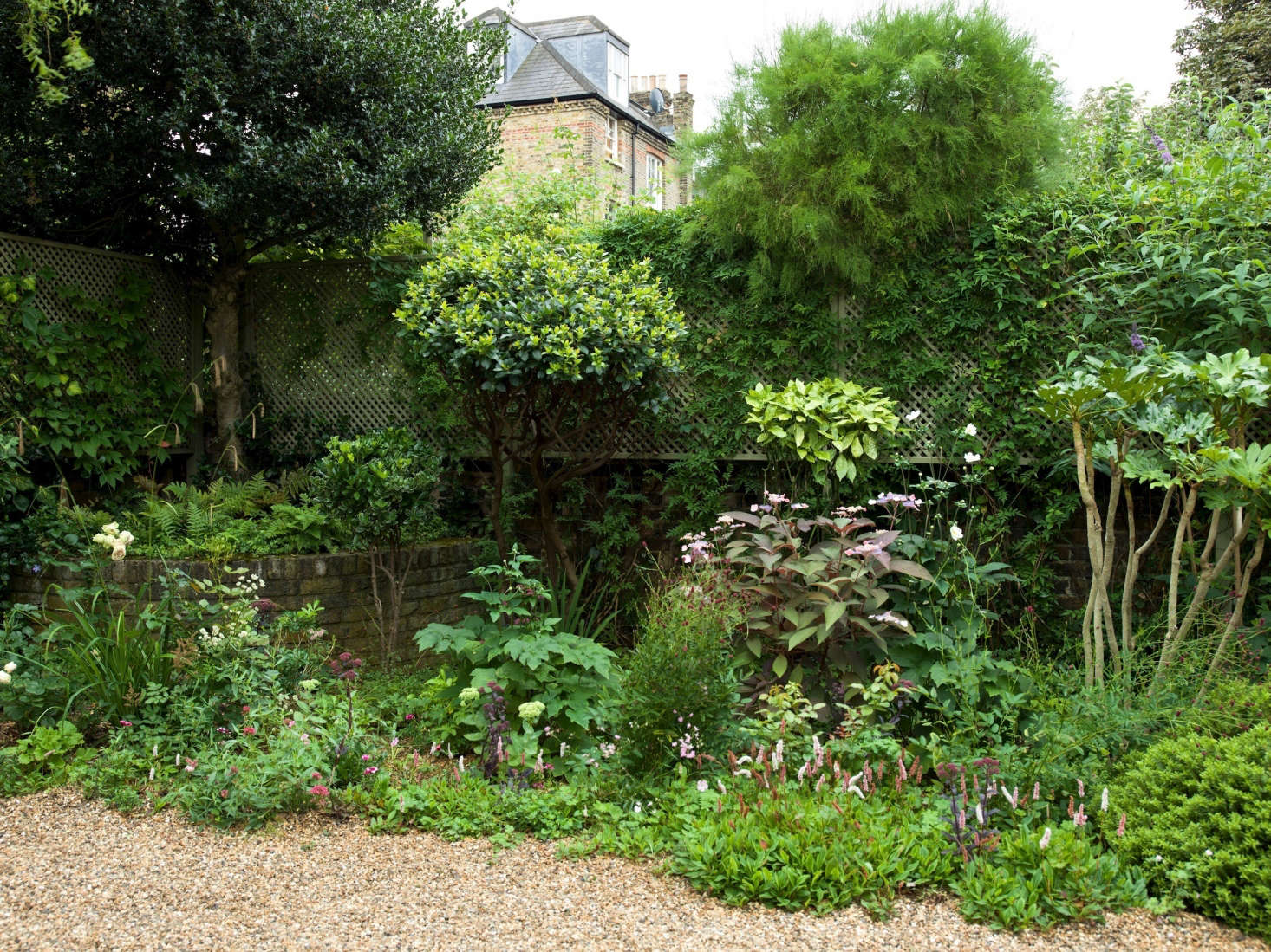 Removing the existing turf and roots by hand was the biggest job—although, Dunster says, it’s a job two people can easily accomplish over a weekend. She then dug out the brick borders that had edged the original flower beds and leveled out any dips with sharp sand.