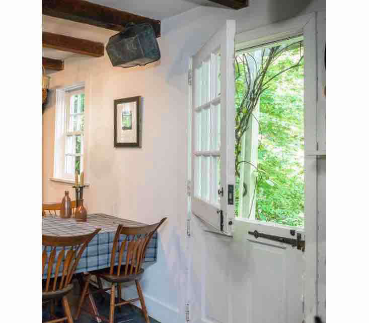 Step inside the Dutch door, into a kitchen with beamed ceilings and a lovely view of the garden.
