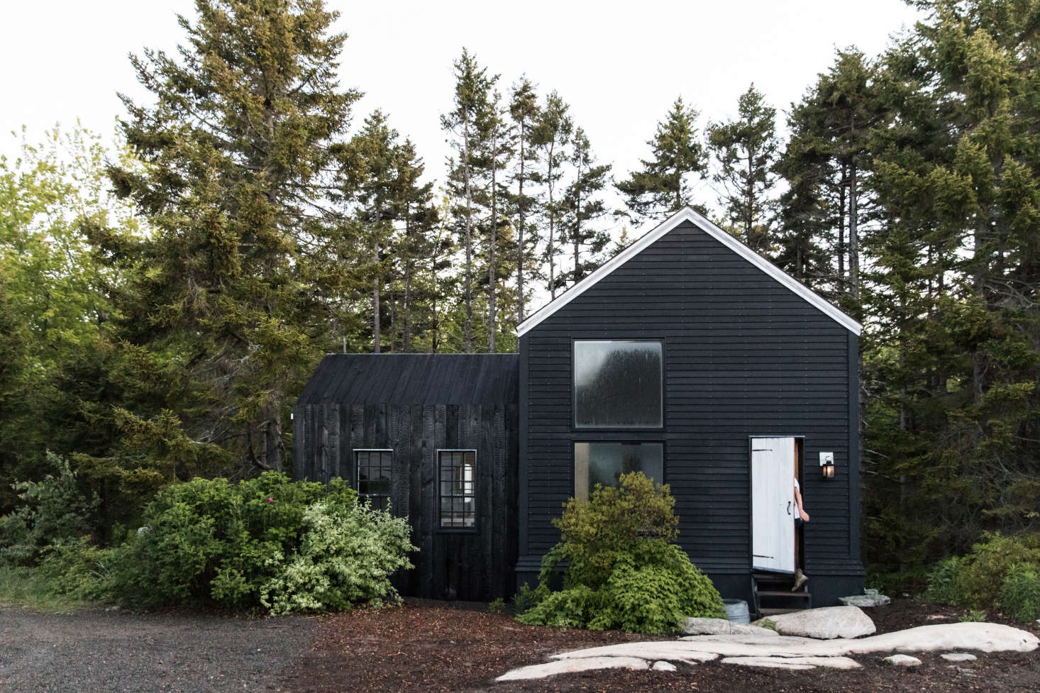 Houses blackened using the age-old technique of shou sugi ban have a texture and richness different from a coat of black paint. Photograph courtesy of Greta Rybus, from The Soot House: Conjuring the Ghosts of Old New England on Spruce Head in Maine.