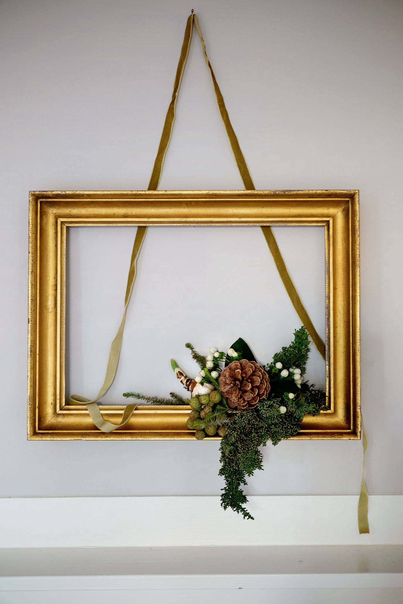 For my vertical element, I added a piece of velvet ribbon, which I informally draped inside and out of the frame. Further details within the greens also enhanced the send of height.