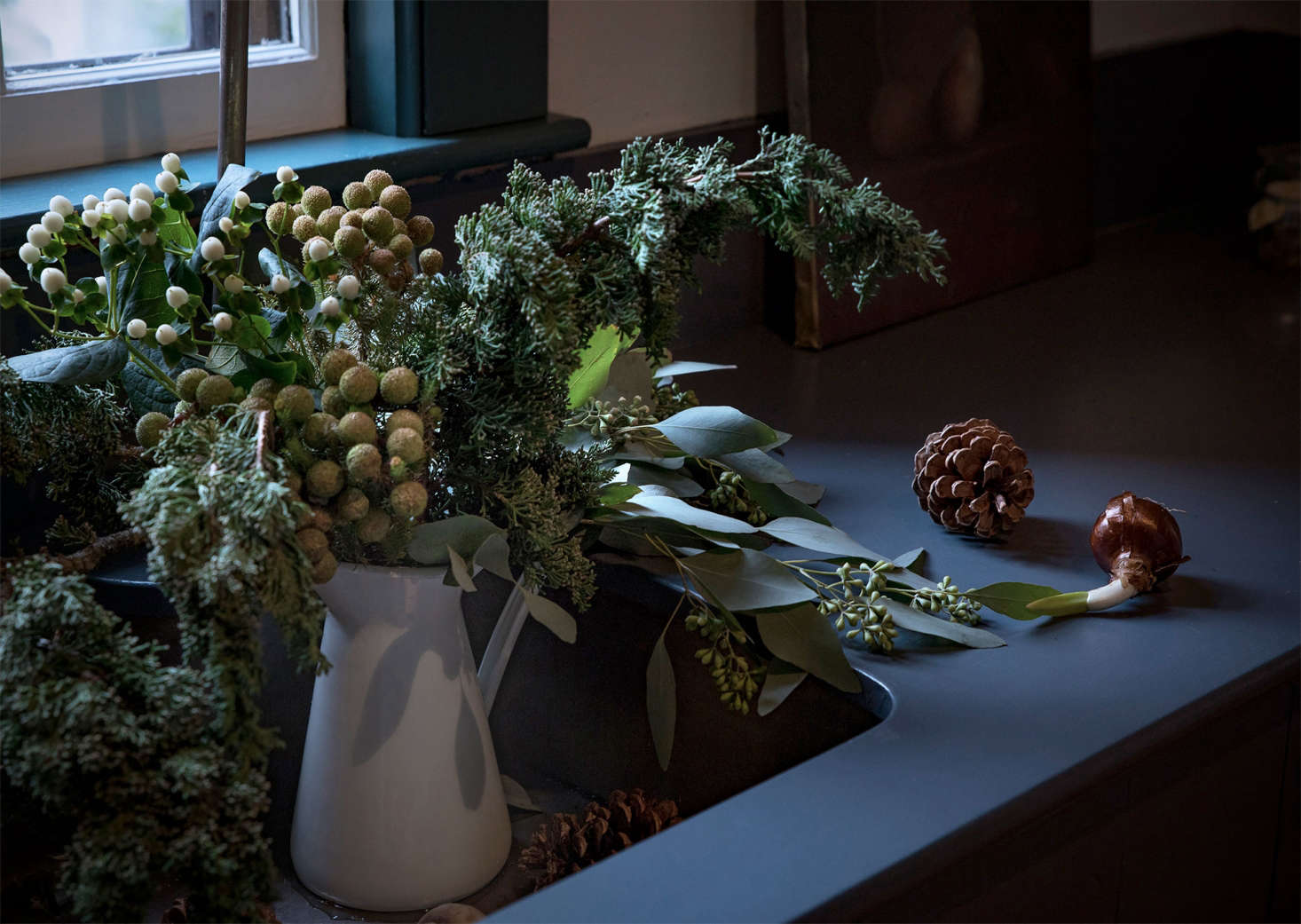 A quick trip outdoors provided the base for a still life with holiday boughs, with foraged juniper evergreens. At the grocery store, I found seeded eucalyptus as well as white Hypericum berries. For a bit of the exotic, I choose Brasilia from my local florist.