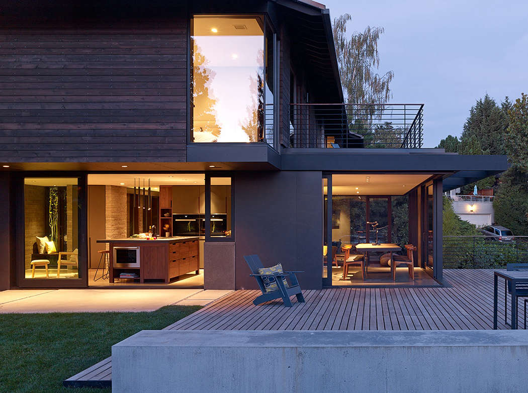 In typical midcentury style, the original kitchen was designed as a utility room, not a social space. The architects removed all its enclosing walls, and replaced one wall with large sliding glass doors that open onto a concrete patio and ipe wood deck.