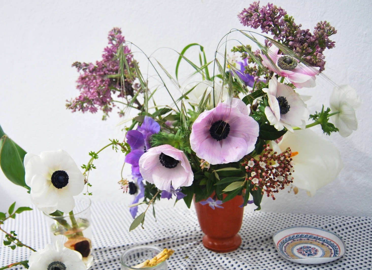 A few sprigs of grass impart an artful wildness to this bouquet of anemones and foraged wildflowers. Photograph and styling by Chelsea Fuss, from Rethinking Anemones: Arranging a Delicate Spring Flower.