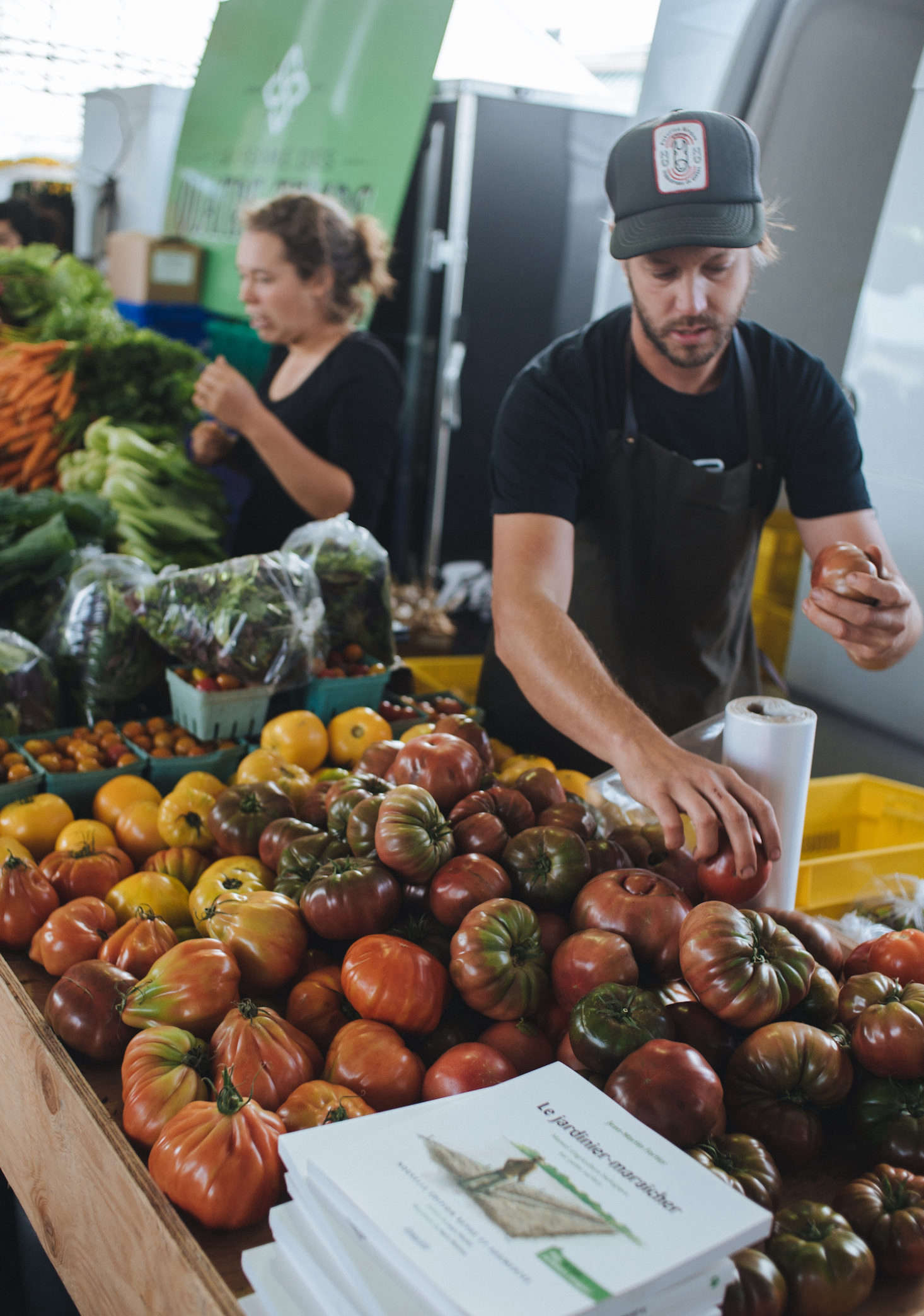 Fortier sells heirloom tomatoes at the market stand.