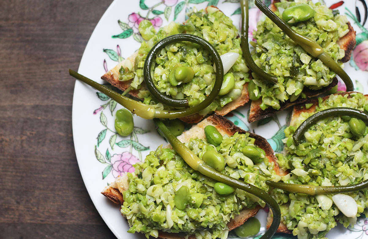 Harvest the scapes when their buds have formed and their stems are doing their sinuous swan-necked thing. Raw, they make a killer and spicy pesto, or blanch them until just tender to add to bruschetta with in-season, mashed-up fava beans.