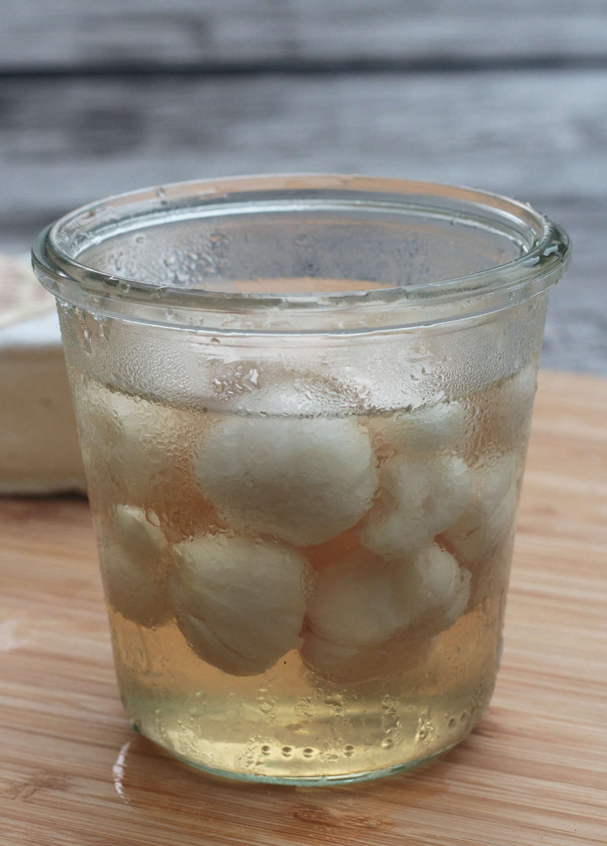 Peel off the outer skin, cut off the stalks, and pack the tender heads in sterile jars. Cover with a data-src=