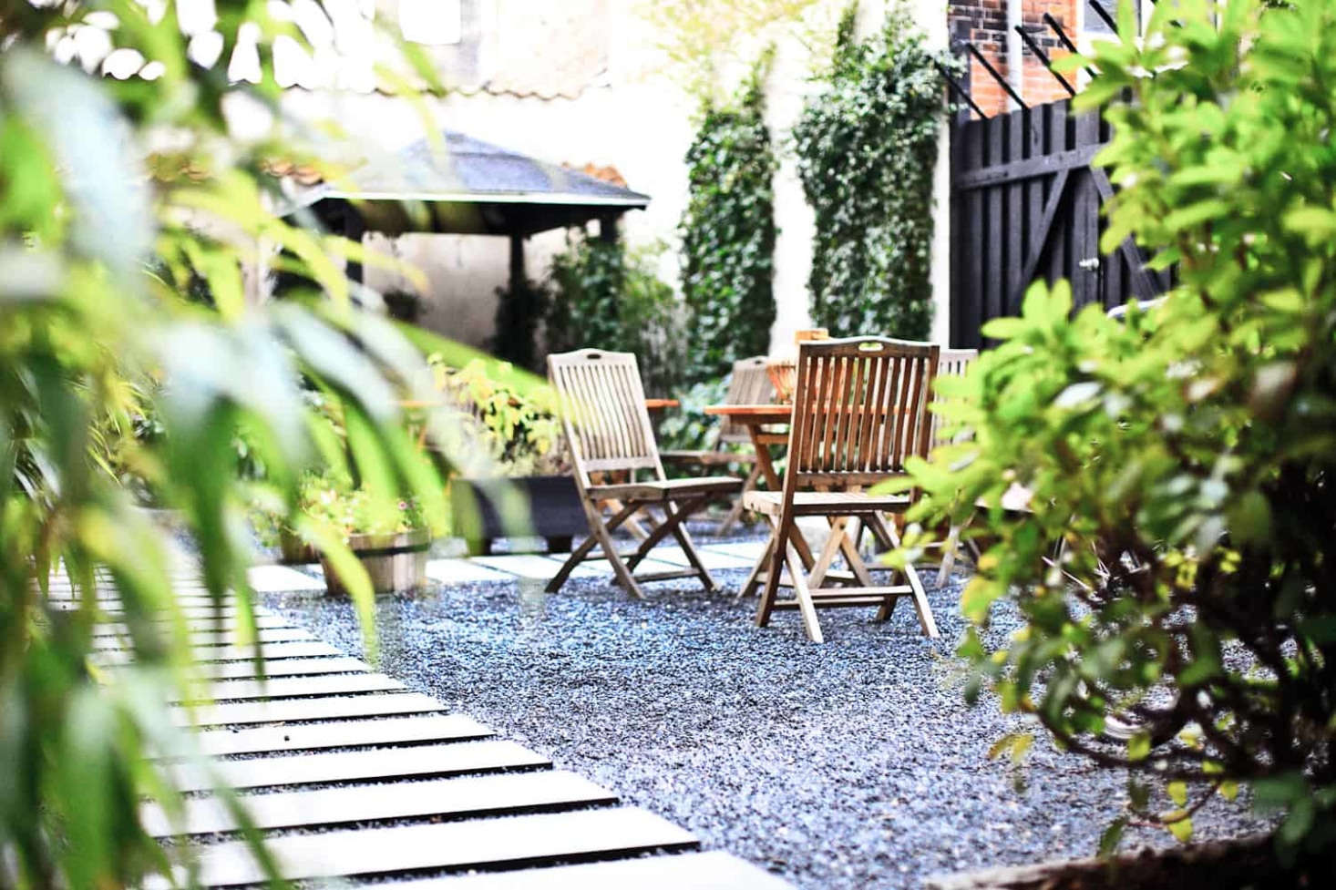 Narrow and long, stone paver strips mimic the look and feel of a beach boardwalk in the garden at Bertrams Guldsmeden hotel in Copenhagen.