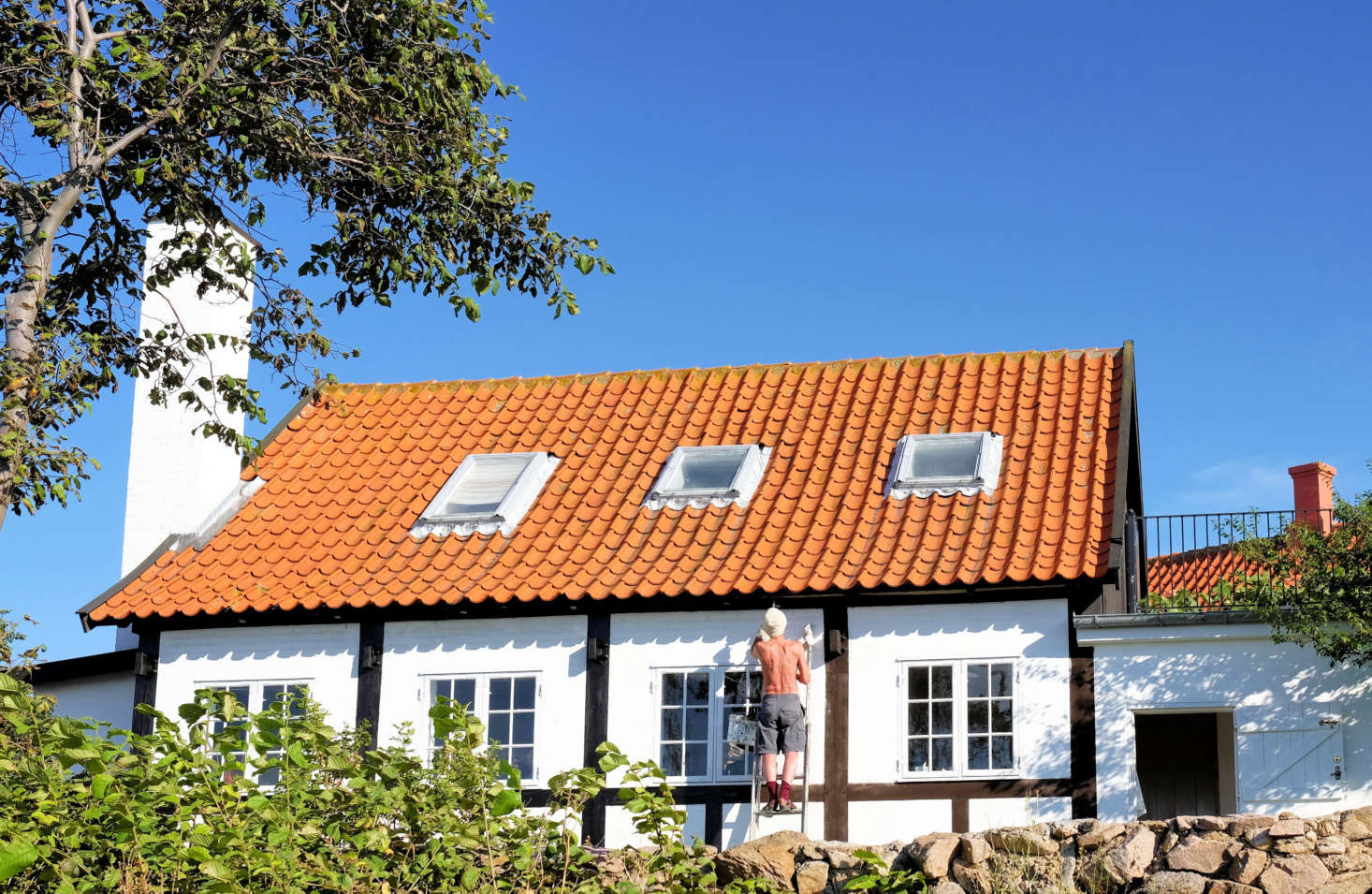 A half-timbered house with a red tile roof (and modern skylights). Photograph by Lars Plougmann via Flickr.