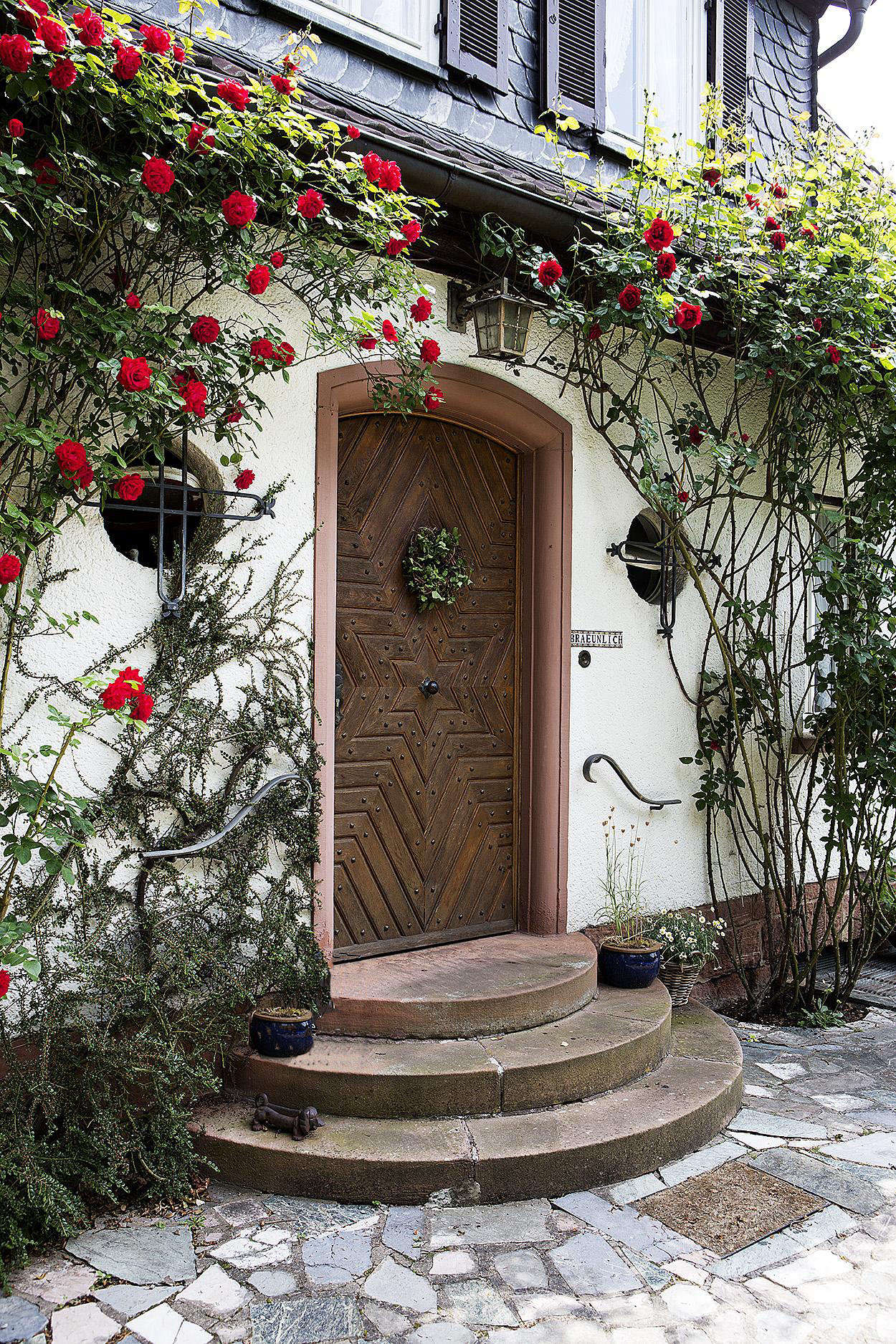 Mismatched stone pavers set in a cement base add a rustic air to an entrance.