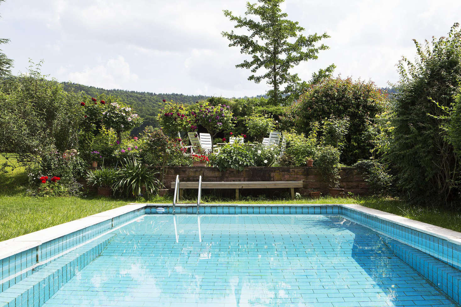 A tiled swimming pool and a raised deck are sited on the side of the house to avoid disrupting views of the countryside.