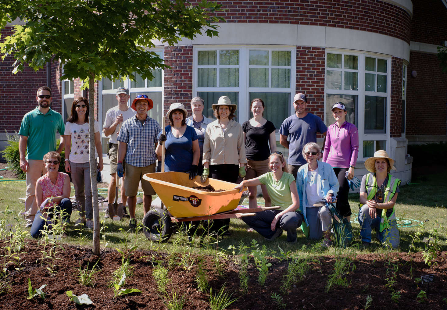 The proud team in Wellesley enjoys its new native pollinator garden.