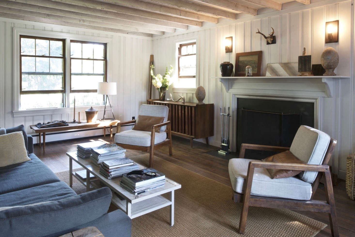 Hydrangeas light up a far corner in a living room of a farmhouse that Brooklyn-based architect Roberto Sosa and his partner, Jeffrey Coe, own in upstate New York. Photograph by Mylene Pionilla.