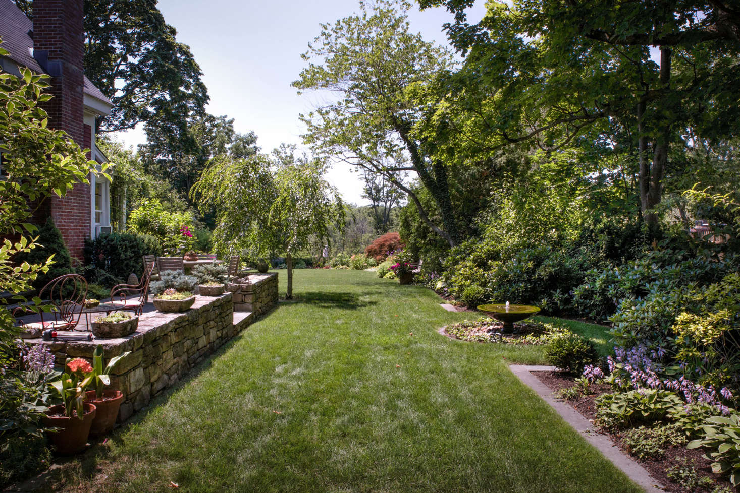 Along the side of the house a stone patio and generous lawn provide a spot for outdoor recreation and entertaining.