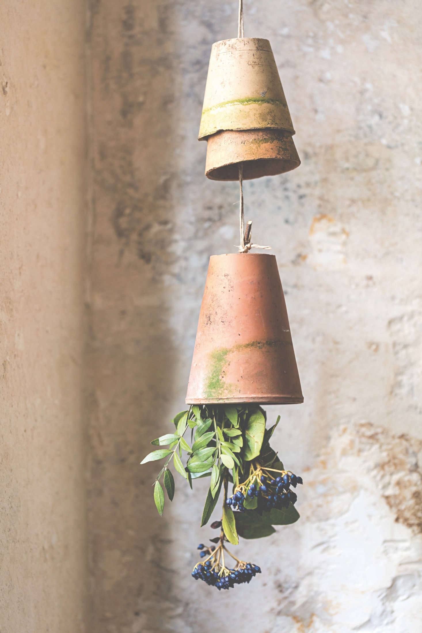Upside down, terra cotta pots with flowers create a charming, unexpected scene.